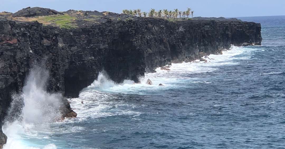 Crashing surf against black rocks